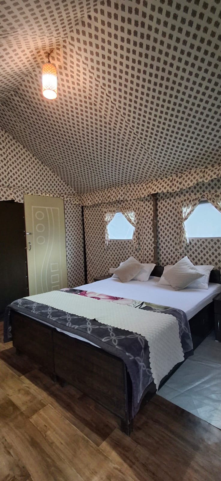 Inside the Swiss tent — intricate patterned fabric ceiling and double bed
